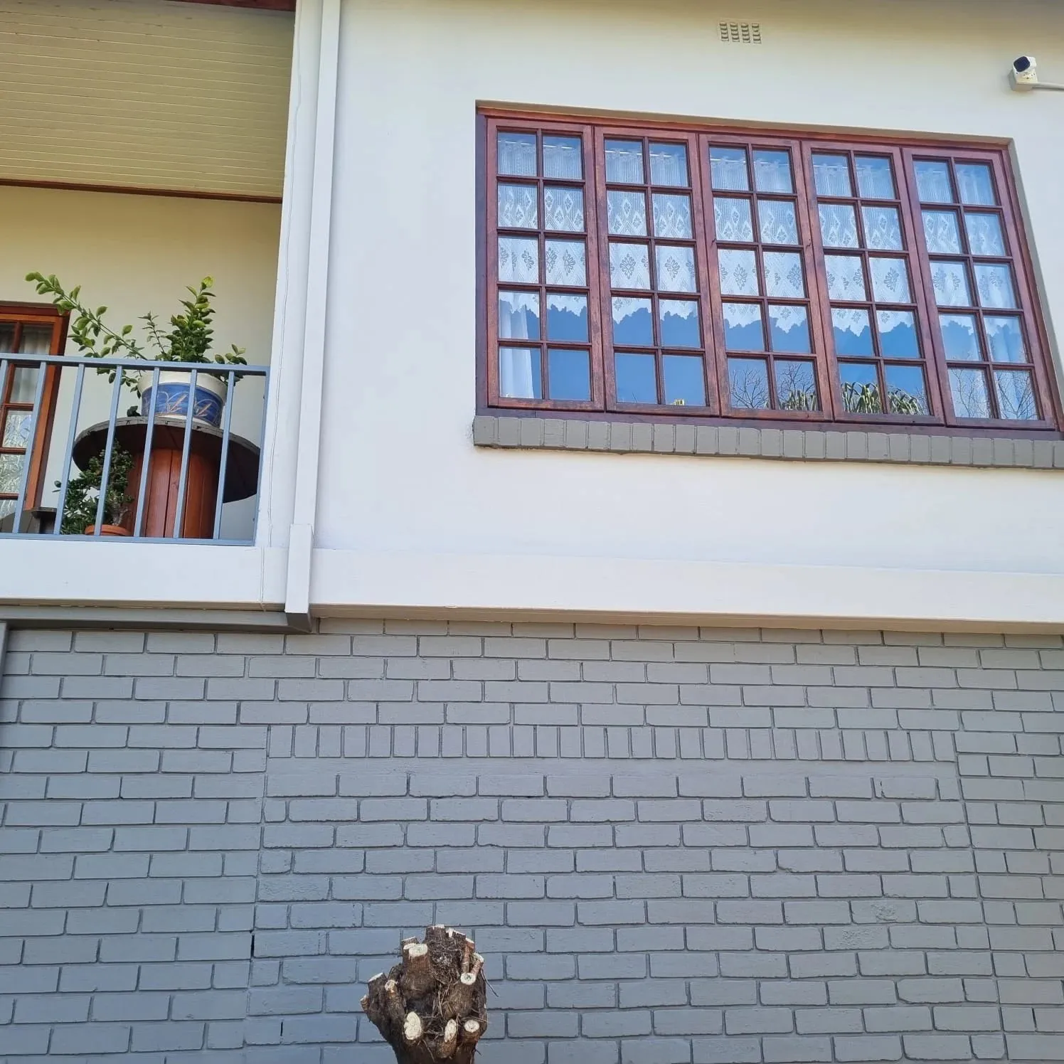 Freshly painted exterior wall with repainted wooden window frames
