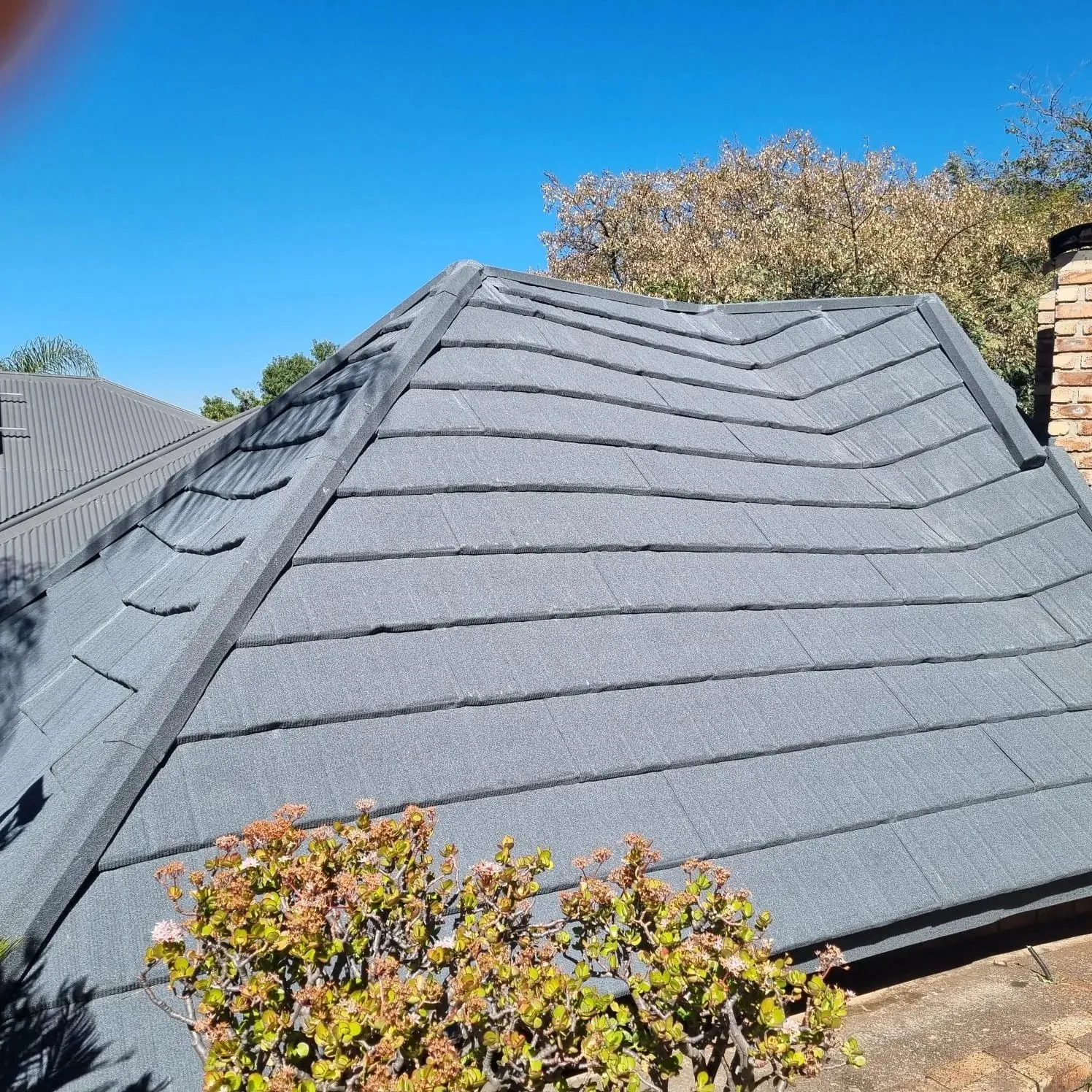 Close-up of a completed stone-coated tile roof