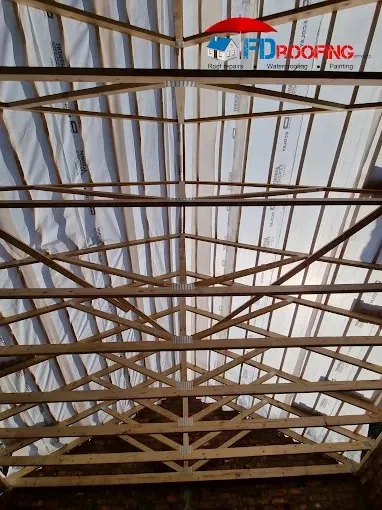 Timber roof trusses and underlay during a new roof erection